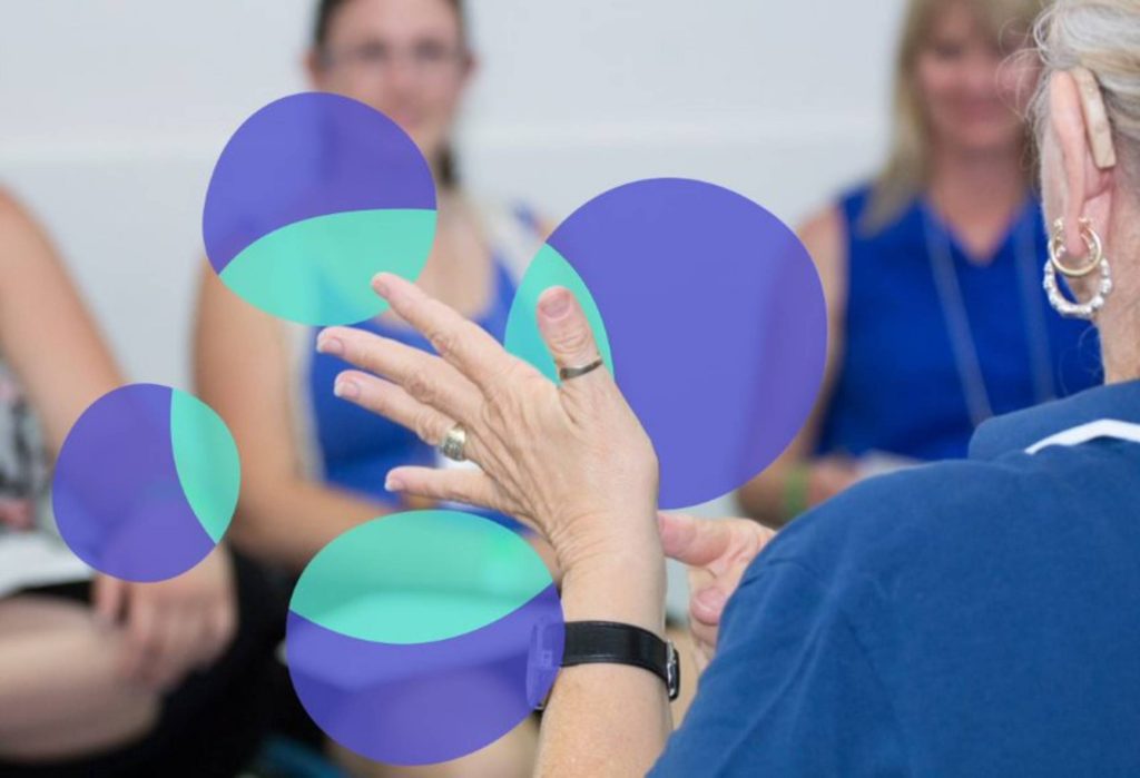 Auslan Teacher signing in front of students in Accredited Auslan Course