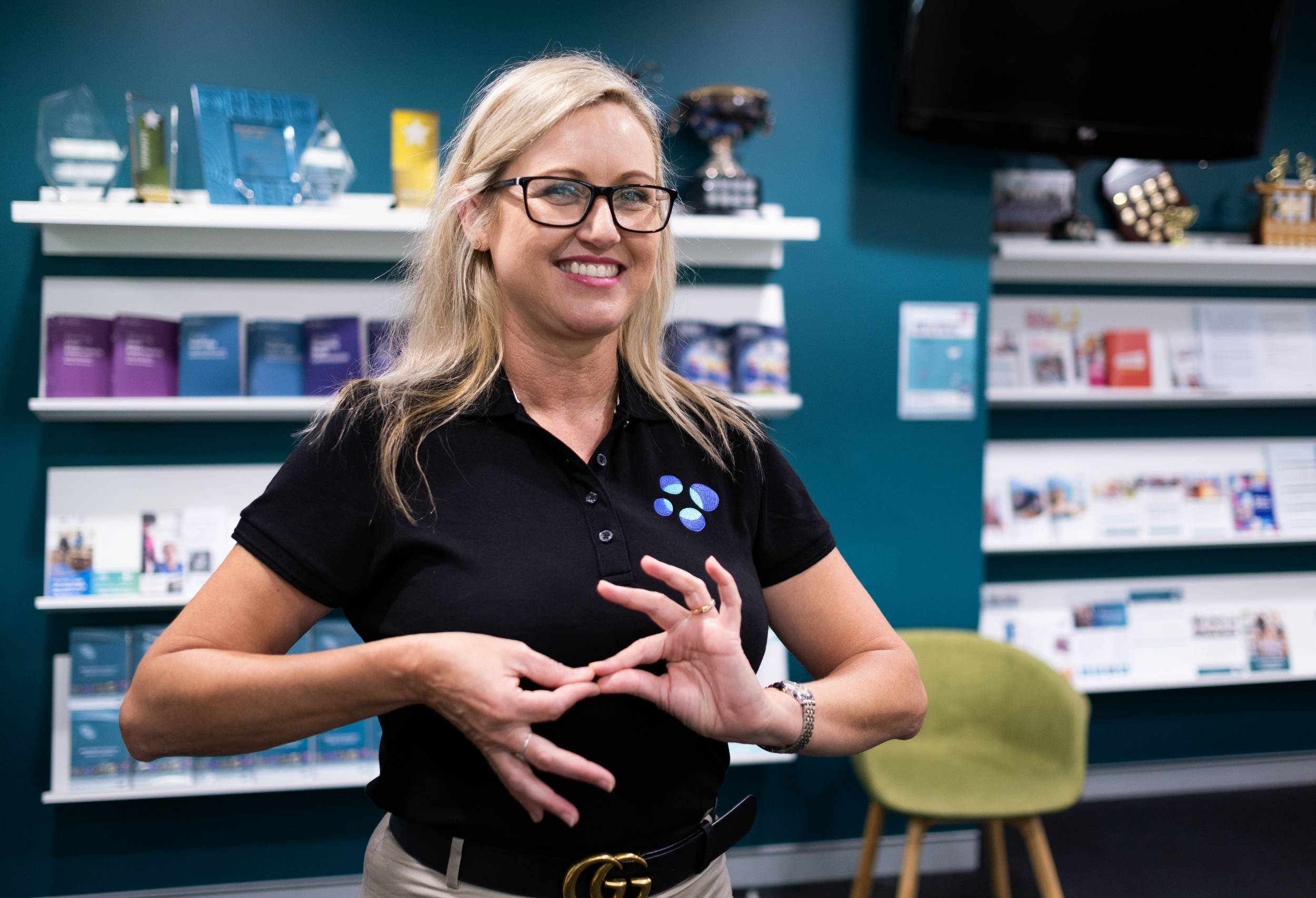 Auslan Interpreter signing 'interpreter' in Australian Sign Language